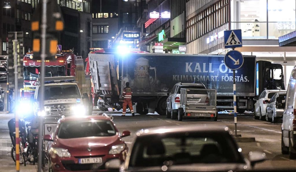 Tow trucks move the beer truck that crashed into the Ahlens department store. Photo: EPA