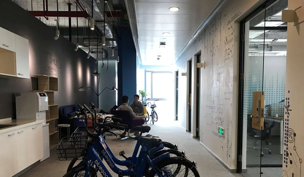 Bicycles are pictured outside the private office of a bicycle-sharing startup at UrWork coworking space in Shenzhen. Photo: Reuters