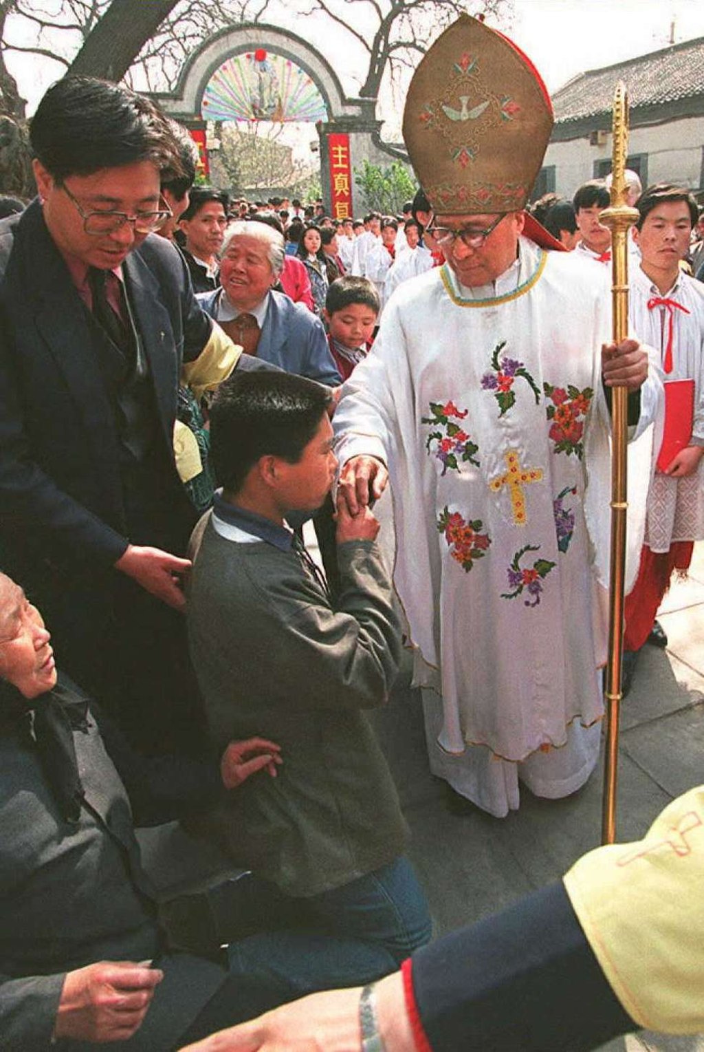 A Chinese Catholic kneels to kiss the ring of Bishop Zong Huaide after the Easter service at Beijing's Xuanwumen Patriotic Catholic Church. Picture: AFP A Chinese Catholic kneels to kiss the ring of Bishop Zong Huaide after the Easter service at Beijing's Xuanwumen Patriotic Catholic Church. Picture: AFP