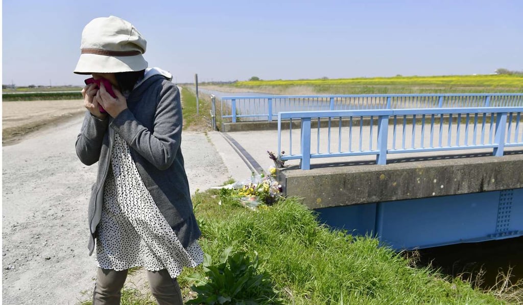 A woman sobs after offering flowers where a nine-year-old Vietnamese girl was found dead in Abiko, near Tokyo. Photo: Kyodo A woman sobs after offering flowers where a nine-year-old Vietnamese girl was found dead in Abiko, near Tokyo. Photo: Kyodo