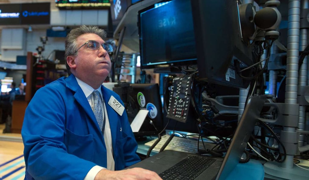 A trader works on the floor at the closing bell of the Dow Jones at the New York Stock Exchange in New York. Last year fewer than a third of active managers succeeded in beating their benchmark. Photo: AFP