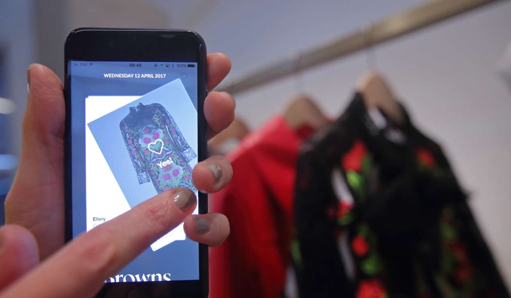 Using Farfetch’s smartphone app, customers can log in when they enter a store and save items they view on racks to a wish list they and sales assistants can view. Photo: Bloomberg Using Farfetch’s smartphone app, customers can log in when they enter a store and save items they view on racks to a wish list they and sales assistants can view. Photo: Bloomberg