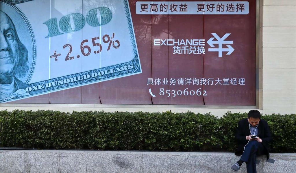 A man browses his phone near a billboard with the US currency displayed outside a bank in Beijing. The US and China have struck what appears to be an unusual bargain as President Donald Trump says he won't label Beijing a currency manipulator and voices confidence Chinese President Xi Jinping will help him deal with North Korea's mounting threat. Photo: AP A man browses his phone near a billboard with the US currency displayed outside a bank in Beijing. The US and China have struck what appears to be an unusual bargain as President Donald Trump says he won't label Beijing a currency manipulator and voices confidence Chinese President Xi Jinping will help him deal with North Korea's mounting threat. Photo: AP