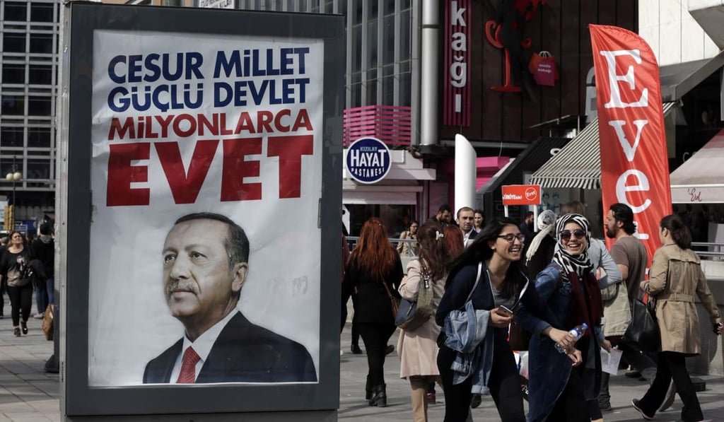 People walk past a ‘yes’ advert in Ankara Photo: AP People walk past a ‘yes’ advert in Ankara Photo: AP