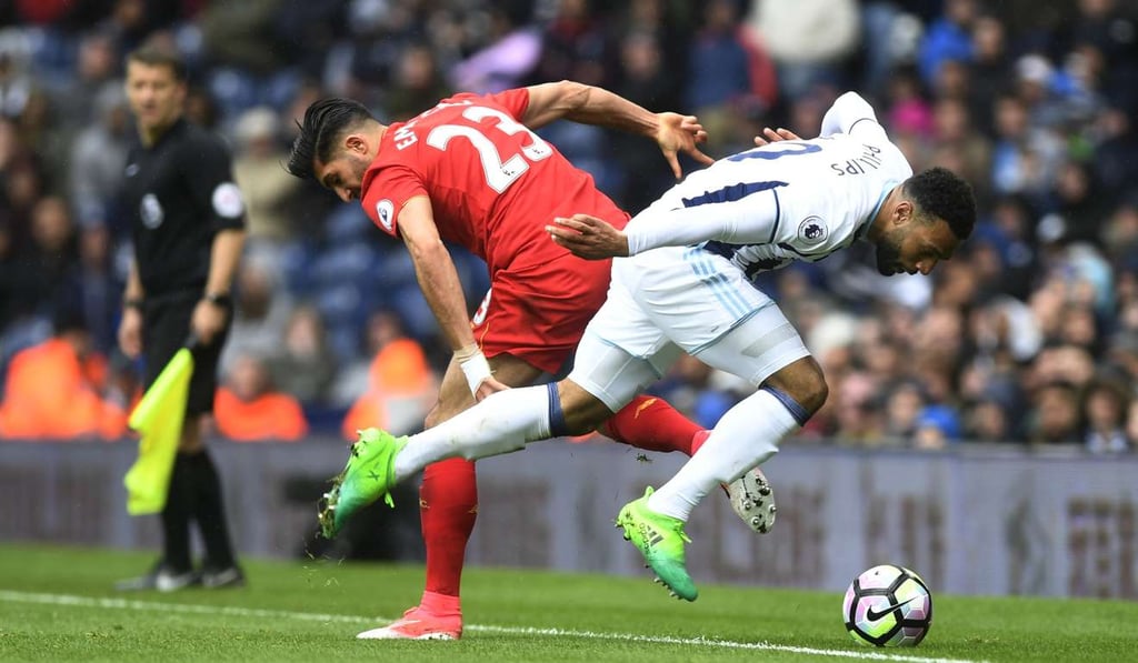 Liverpool's Emre Can (left) and West Brom’s Matt Phillips vie for the ball. Photo: EPA