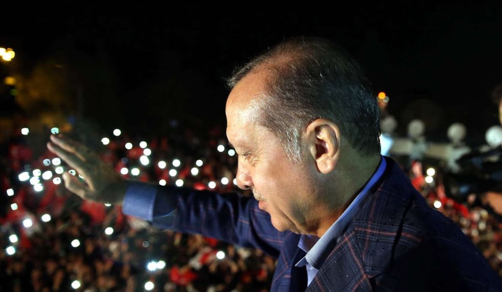 A handout photo made available by Turkish President Press office Turkish President Recep Tayyip Erdogan waving to supporters during a rally in front of the residence in Istanbul on Sunday. Photo: EPA