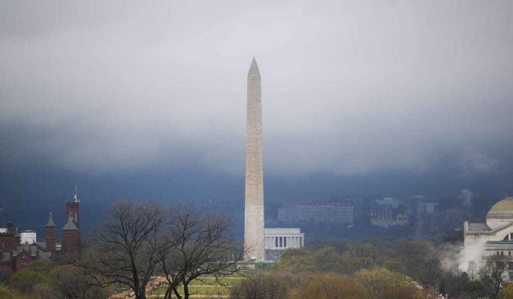 Storm clouds form around the Washington Monument and Lincoln Memorial in Washington. Photo: AP