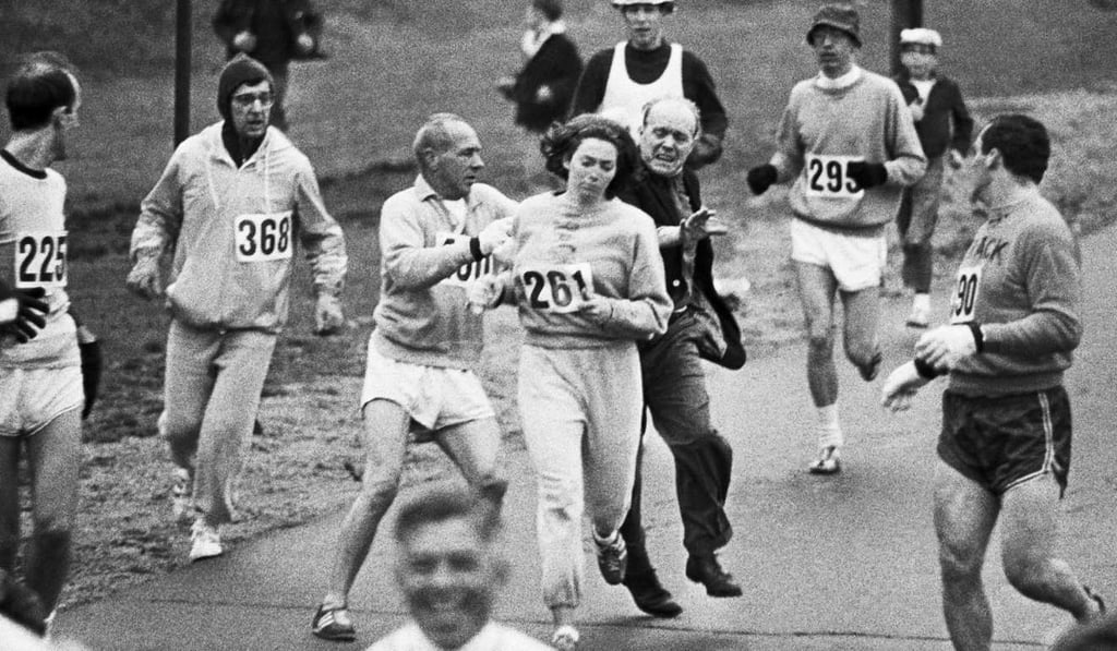 In 1967, challenging the all-male tradition of the Boston Marathon, Kathrine Switzer entered the race. Two miles in, a race official tried to physically remove her from the course. Photo: AP
