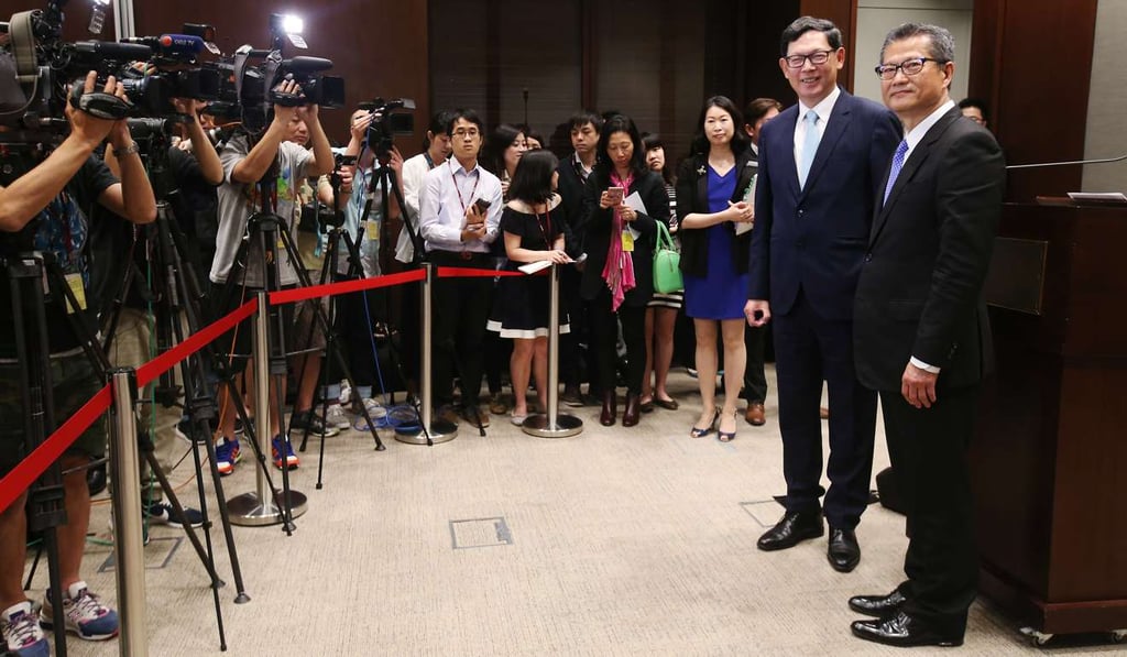 Norman Chan Tak-lam, chief executive of the Hong Kong Monetary Authority, and Paul Chan Mo-po, financial secretary, announce the new life annuity scheme from the government-owned Hong Kong Mortgage Corporation, on April 10. Photo: David Wong