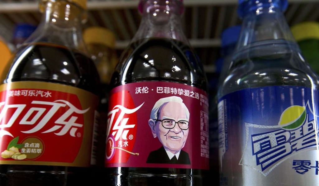 A bottle of Cherry Coca-Cola with a portrait of Berkshire Hathaway Chairman and CEO Warren Buffett sits on a shelf with other soft drinks at a convenience store in Beijing, China. Photo: AP A bottle of Cherry Coca-Cola with a portrait of Berkshire Hathaway Chairman and CEO Warren Buffett sits on a shelf with other soft drinks at a convenience store in Beijing, China. Photo: AP