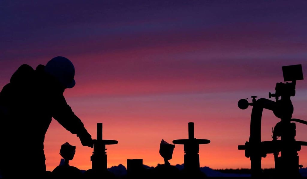 A worker checks the valve of an oil pipe at an oil field owned by Russian state-owned oil producer Bashneft near the village of Nikolo-Berezovka, northwest of Ufa, Bashkortostan, Russia. Crude prices slid to their lowest in two weeks due to bumper supplies. Photo: Reuters