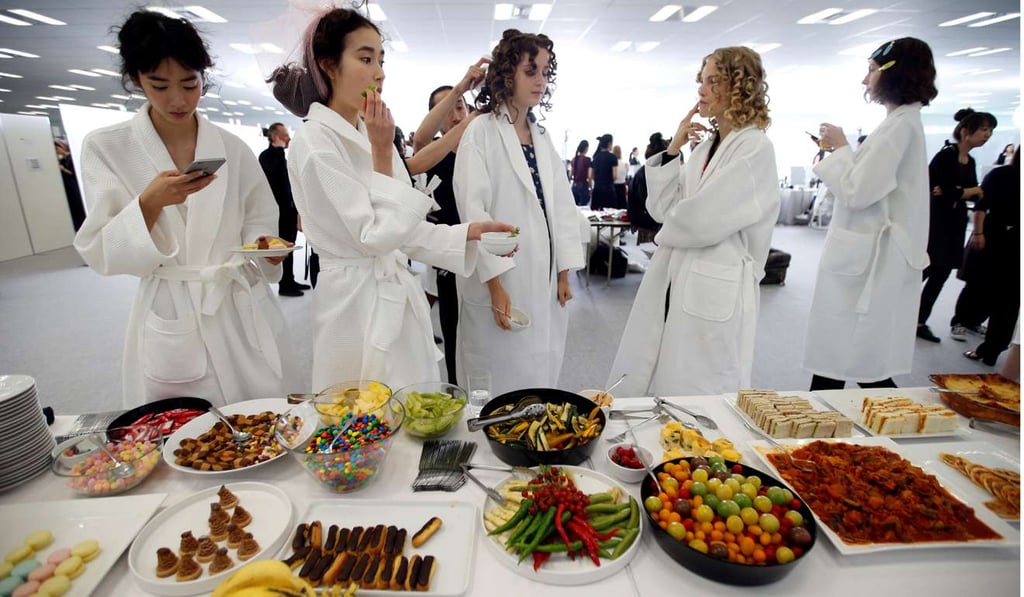 Models eat backstage at Christian Dior’s spring-summer 2017 haute couture show at Ginza Six. Photo: REUTERS/Toru Hanai