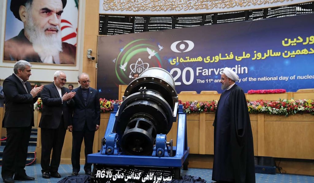 A handout picture released by the official website of the Iranian President Hassan Rouhani shows him (R), the Head of the Iranian Atomic Energy Organization Ali Akbar Salehi (2R) and Iranian Foreign Minister Javad Zarif (2L) as they celebrate nuclear achievements during a ceremony marking the National day of Nuclear Technology in Tehran. Photo: AFP