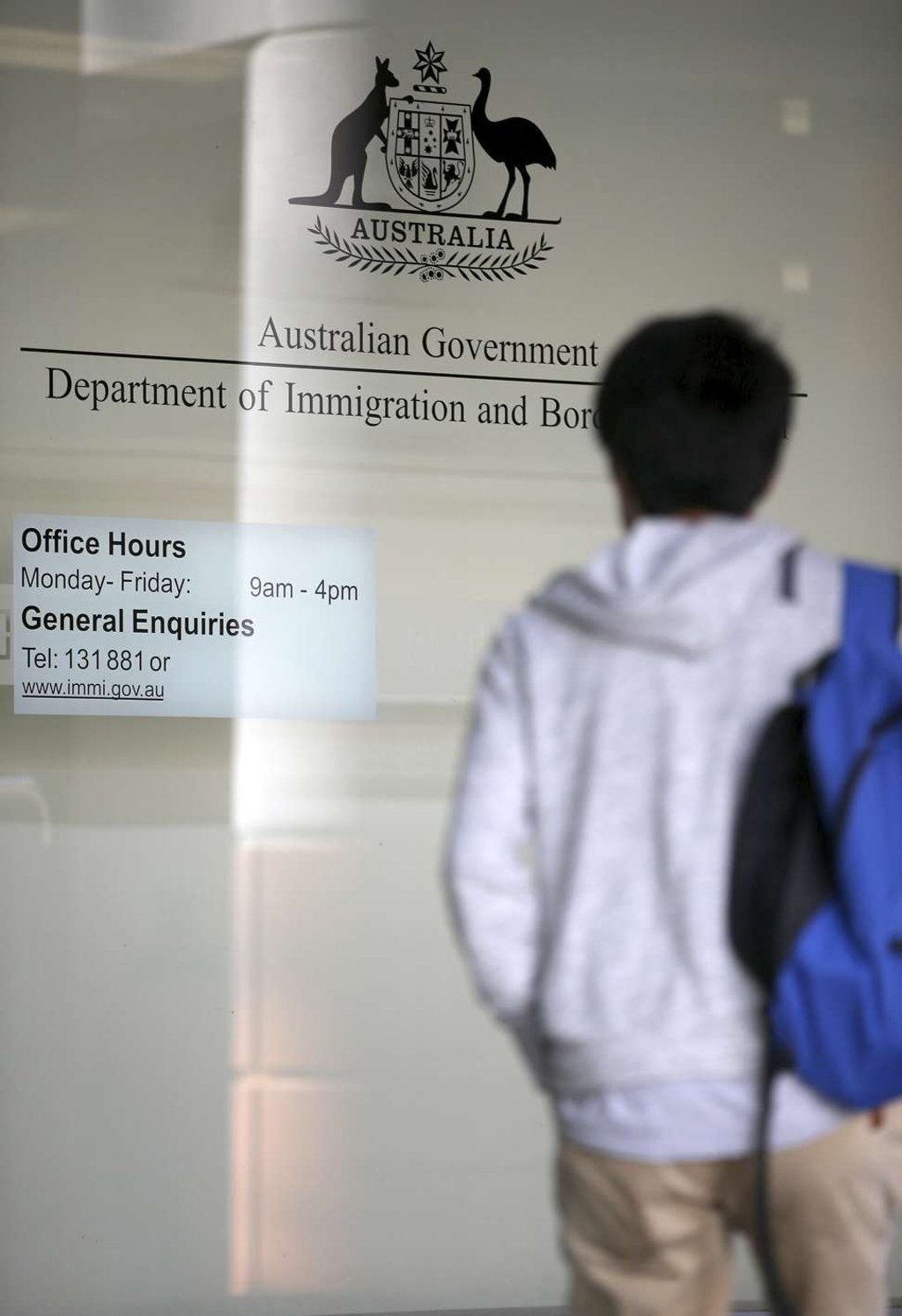 A man arrives at the Department of Immigration and Border Protection offices in Sydney. Australia plans to tighten its citizenship rules to require higher English language skills, longer residency and evidence of integration such as a job. Photo: AP