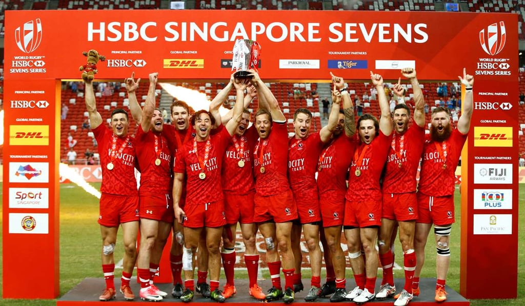Canada players soak up the glory with the trophy. Photo: Reuters