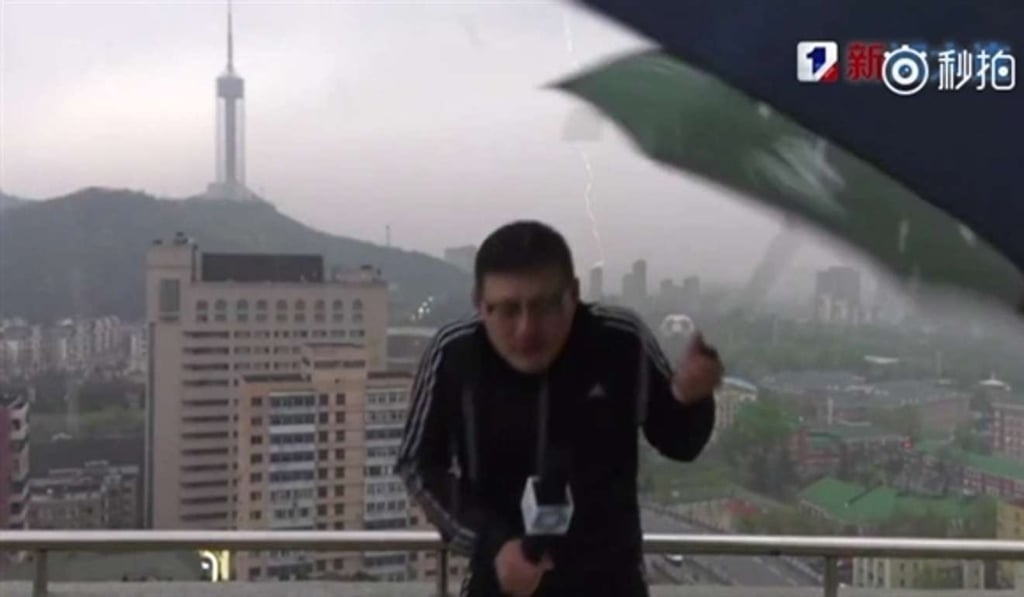 Lu Xiaodong let out a cry and dropped his umbrella when he was struck by lightning sparks while filming in Dalian, Liaoning province, on Monday morning. Photo: Handout