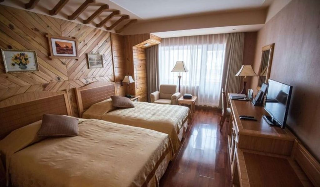 The luxury resort and hotel are a world away from the scenes outside the entrance checkpoint, where peasant farmers drag sleds loaded with firewood across frozen lakes, and ox-drawn carts are used for transport. Photo: AFP The luxury resort and hotel are a world away from the scenes outside the entrance checkpoint, where peasant farmers drag sleds loaded with firewood across frozen lakes, and ox-drawn carts are used for transport. Photo: AFP