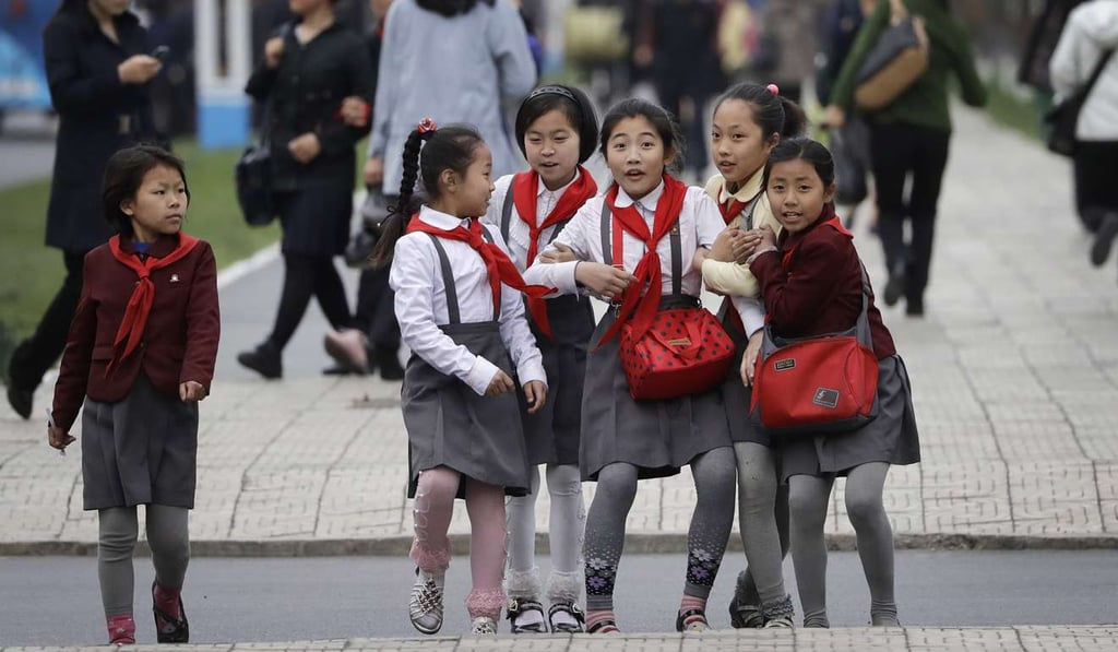North Korean schoolgirls react upon seeing their photograph being taken as they walk along Mirae Scientists Street in Pyongyang. If a military conflict breaks out on the Korean peninsula, China has much to lose. Photo: AP