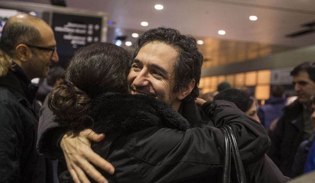 Mazdak Tootkaboni, a US green card holder from Iran, is embraced during a demonstration against Donald Trump’s travel ban on citizens from a handful of predominantly Muslim countries. Photo: AFP Mazdak Tootkaboni, a US green card holder from Iran, is embraced during a demonstration against Donald Trump’s travel ban on citizens from a handful of predominantly Muslim countries. Photo: AFP