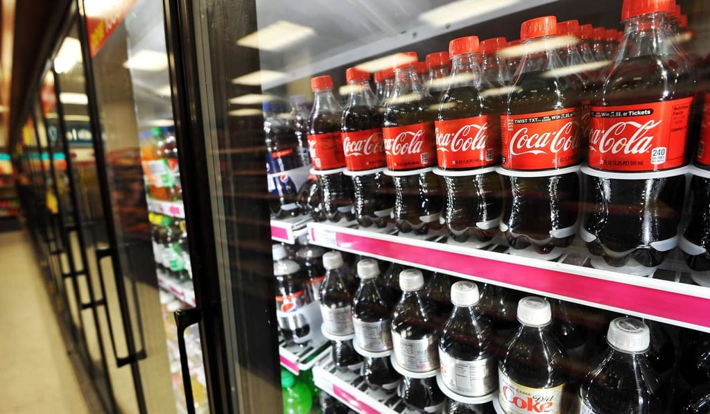 Bottles of Coca Cola products at a store in Washington,DC. Coca-Cola reported it will cut 1,200 jobs due to low sales and flat volumes as it touts new low-sugar beverages in response to flagging demand for soda. Photo: AFP Bottles of Coca Cola products at a store in Washington,DC. Coca-Cola reported it will cut 1,200 jobs due to low sales and flat volumes as it touts new low-sugar beverages in response to flagging demand for soda. Photo: AFP