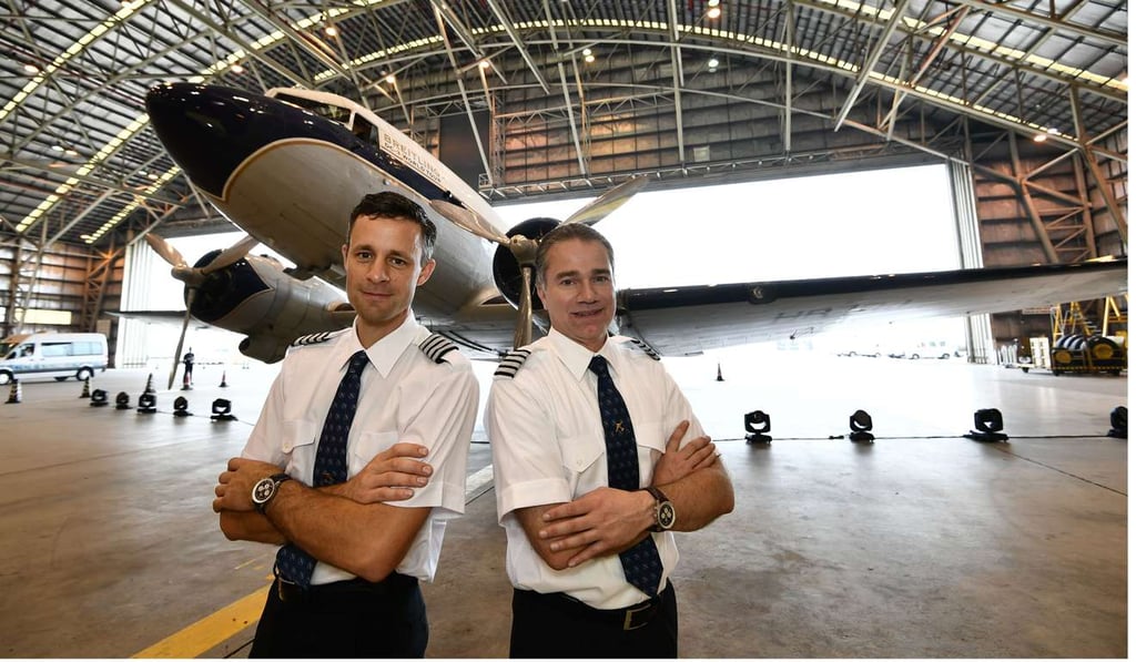 Captain of Breitling DC-3, Francisco Agullo (right), stands in front of Breitling DC-3 at Macau International Airport.