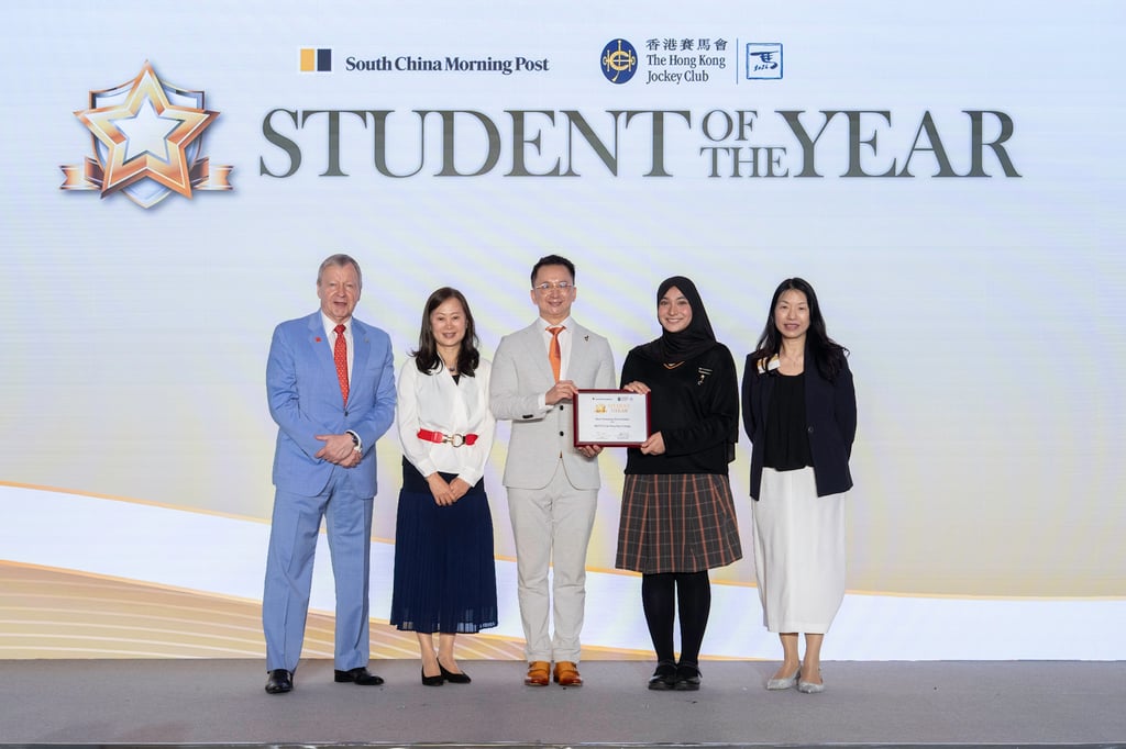 Winfried Engelbrecht-Bresges, Chief Executive Officer of The Hong Kong Jockey Club (first from the left) and Tammy Tam, Publisher of the South China Morning Post (second from the left) present the Special Award for Most Nurturing Environment to HKFYG Lee Shau Kee College.