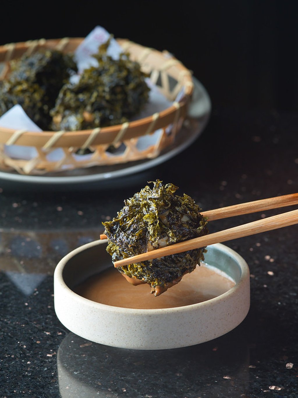 Chiu Chow Seaweed Poppers reinterpret hand-pounded cuttlefish balls in seaweed soup as crisp bites served with black garlic mayonnaise and lemon. Chiu Chow Seaweed Poppers reinterpret hand-pounded cuttlefish balls in seaweed soup as crisp bites served with black garlic mayonnaise and lemon.