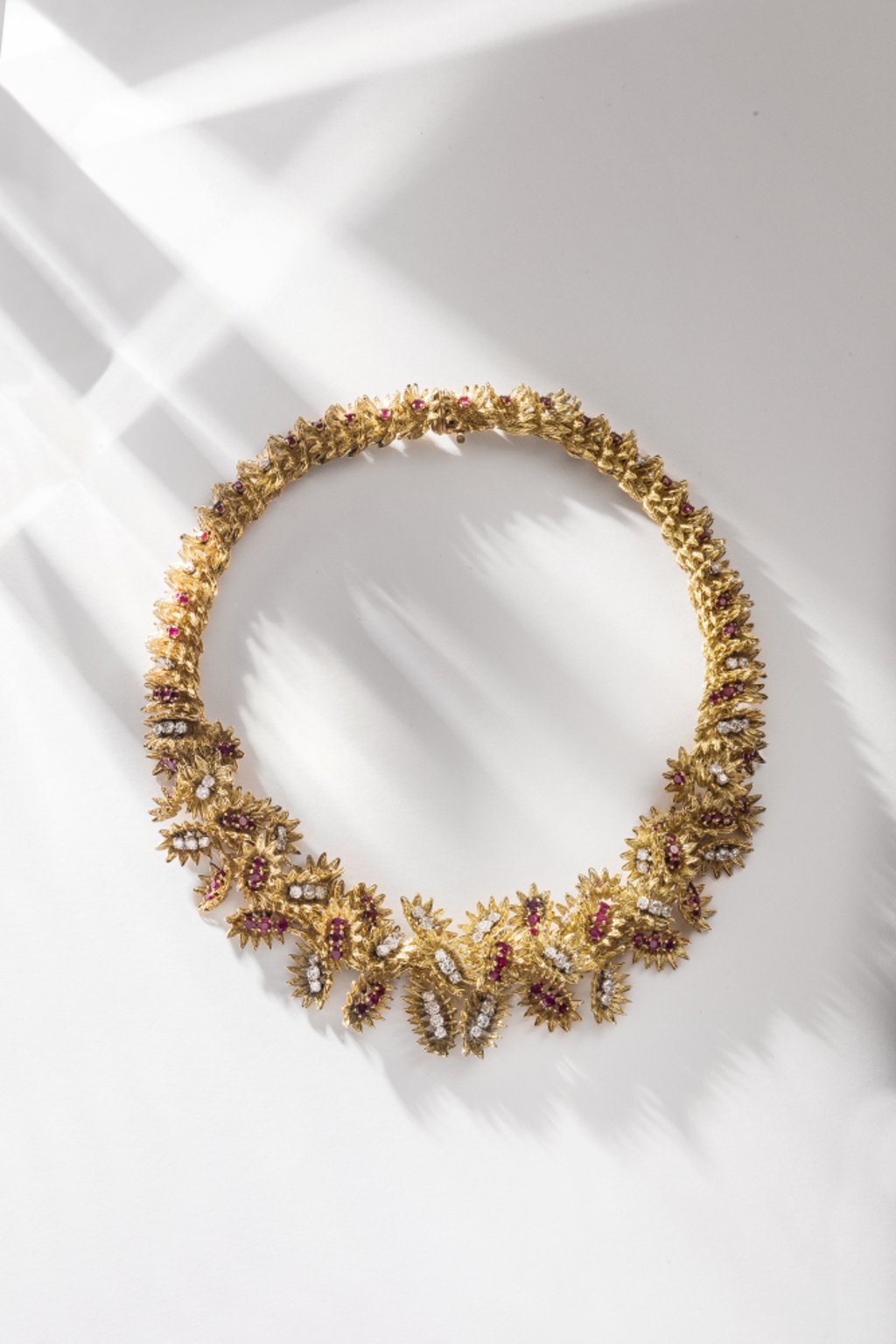 Flower necklace in yellow, pink, and white gold and platinum, with rubies and diamonds, from 1965.