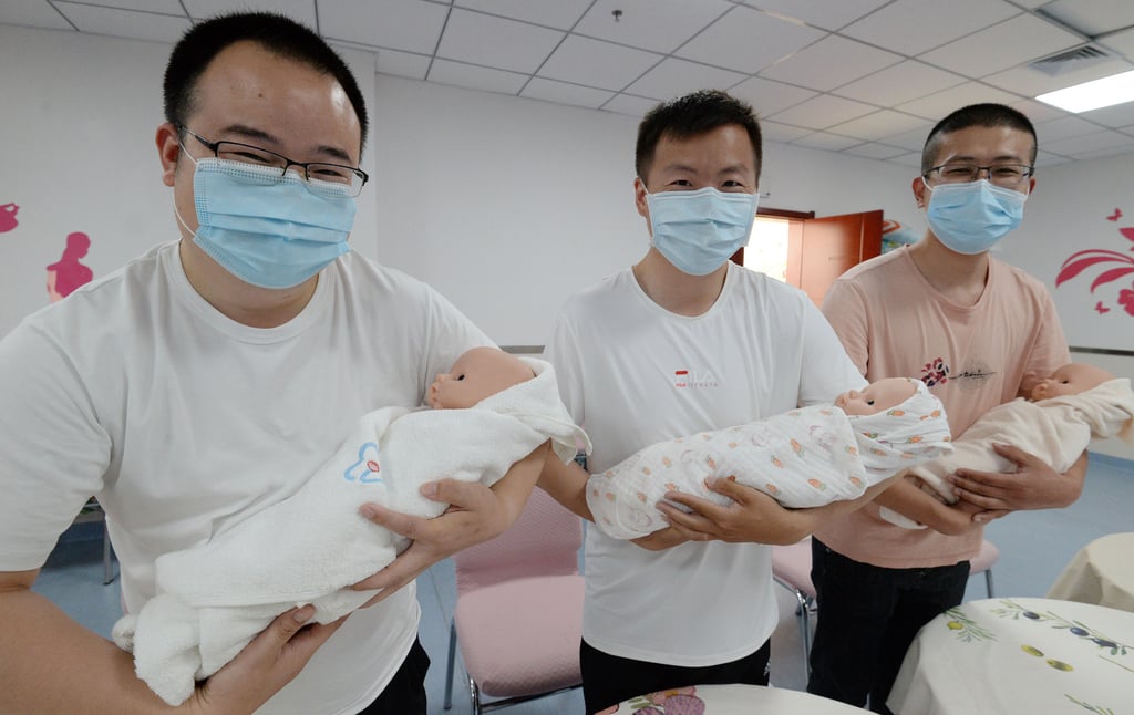 Fathers-to-be learn to take care of newborns at a maternal hospital in Handan in north China. Photo: Barcroft Media via Getty Images