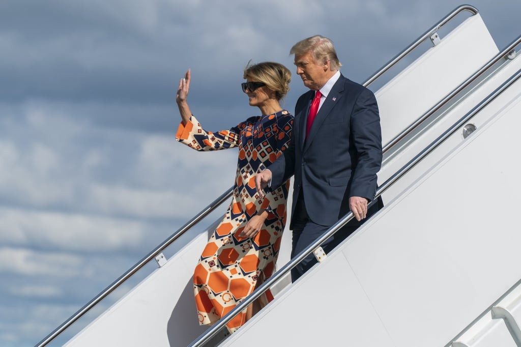 Melania Trump waves as she disembarks from her final flight on Air Force One wearing a colourful Gucci dress – ever the style maven, she was nevertheless not known for championing US designers. Photo: AP