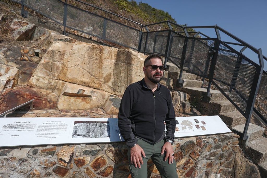 Marc Rubinstein with rock carvings in Big Wave Bay, Hong Kong Island. Photo: Jonathan Wong Marc Rubinstein with rock carvings in Big Wave Bay, Hong Kong Island. Photo: Jonathan Wong