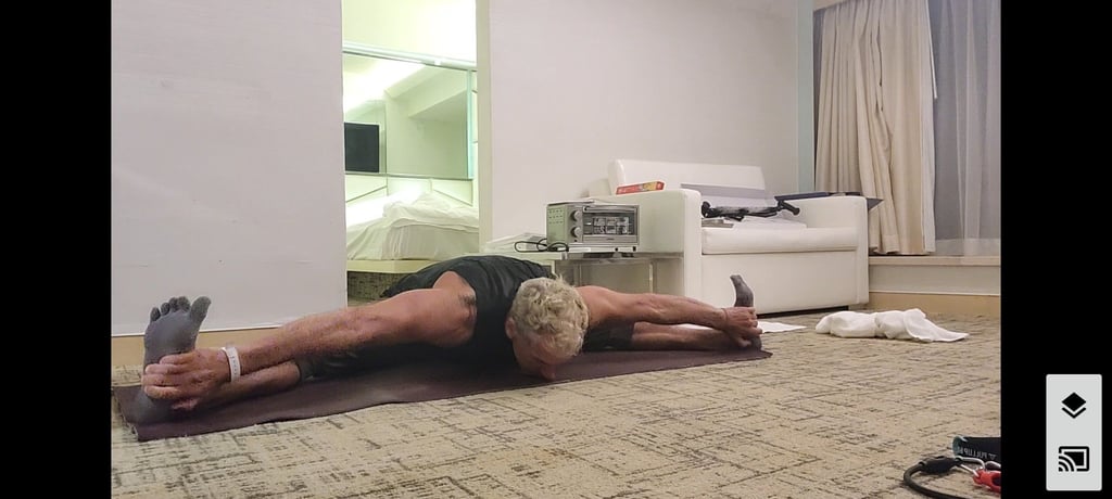 Andy Willner doing the seated forward bend pose (upavistha konasana) during his quarantine in a hotel. Photo: Andy Willner
