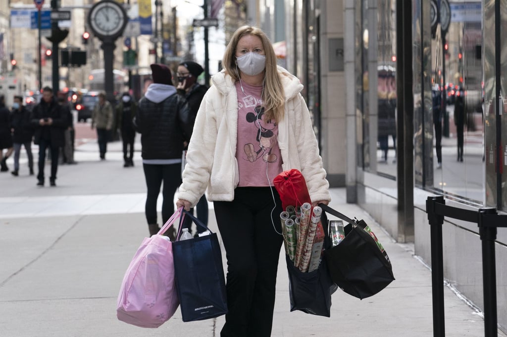 A woman carries shopping bags in New York on December 10, 2020. US policymakers see continuing low Treasury yields as an integral part of the campaign to re-energise the economy. Photo: AP