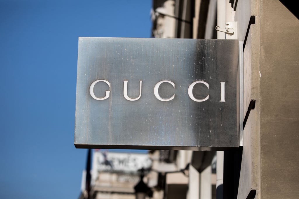 A sign hangs outside a Gucci Group NV luxury clothing fashion store on Rue Royale in Paris, France. Photo: Bloomberg