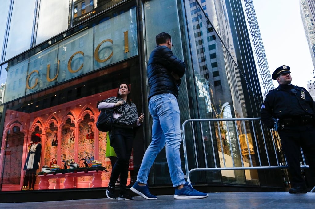People walk in front of the Gucci store at Fifth Avenue at the Trump Tower. Photo: AFP