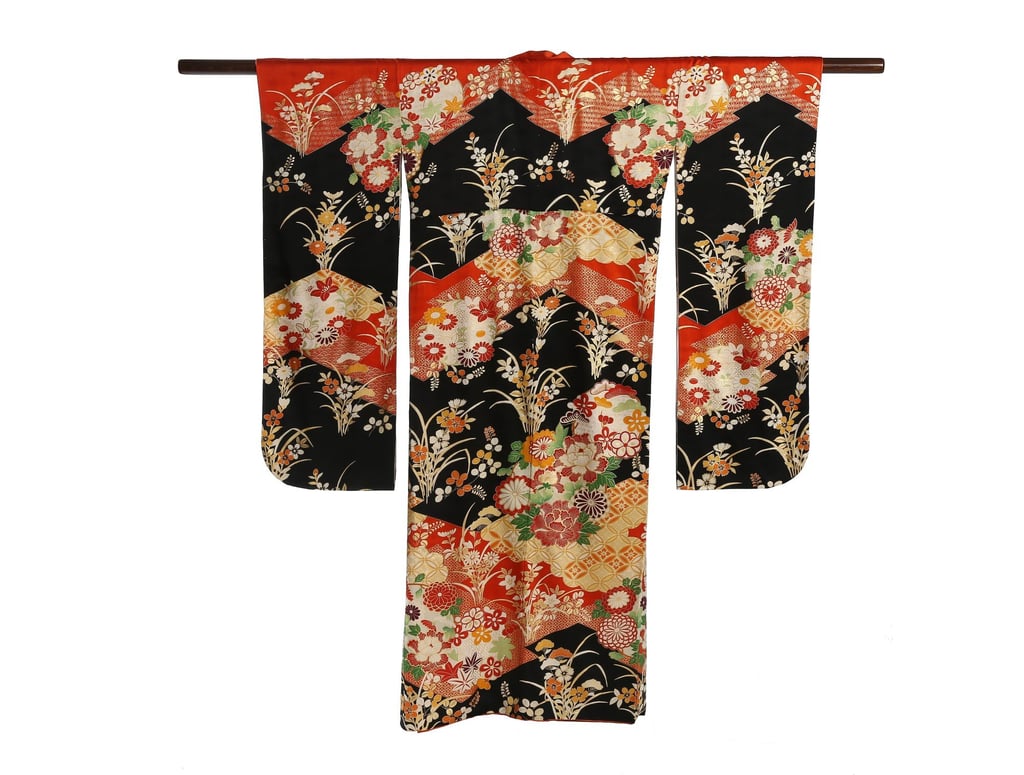 A black and terracotta resist-dyed, crepe silk furisode with spring blossoms from the exhibition. Photo: courtesy of Altfield Gallery