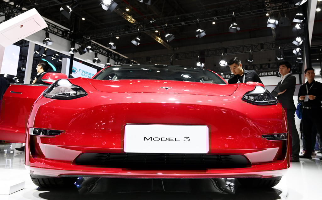 Visitors view a Tesla Model 3 during the 18th Shanghai International Automobile Industry Exhibition. Photo: Xinhua