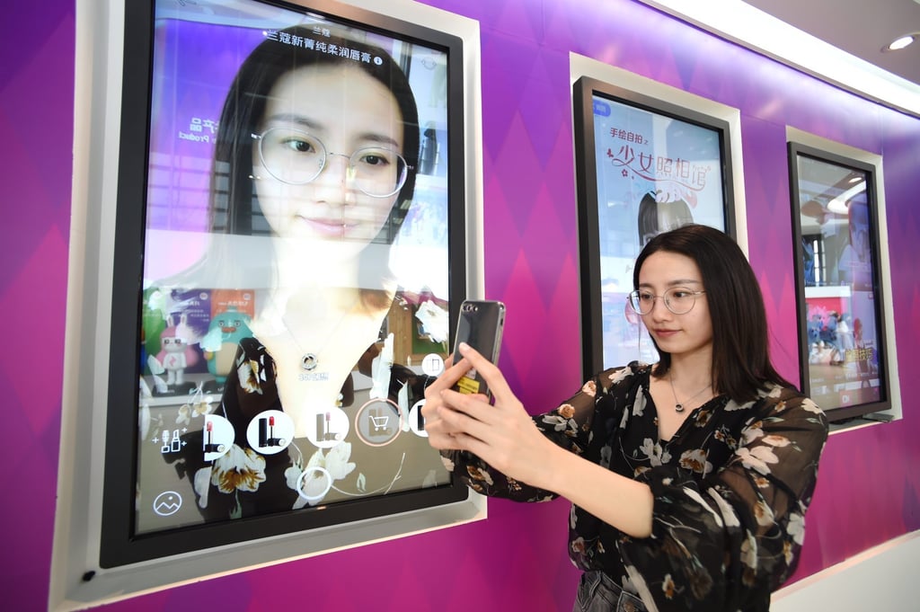 A Meitu employee shows the features of the app in Xiamen, southeast China’s Fujian province. Meitu became the first Hong Kong-listed company to invest its cash reserves into bitcoin. Photo: Xinhua