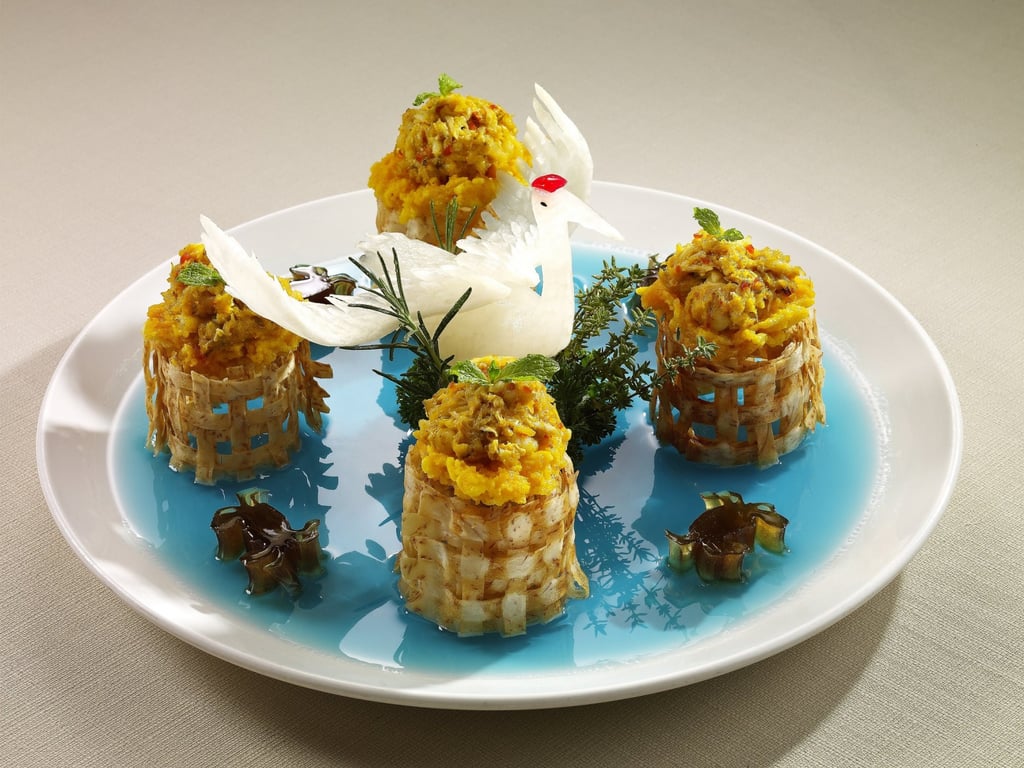 Wok-fried crabmeat and rock lobster with salted egg yolk on rice crackers. Photo: Dong Lai Shun Wok-fried crabmeat and rock lobster with salted egg yolk on rice crackers. Photo: Dong Lai Shun