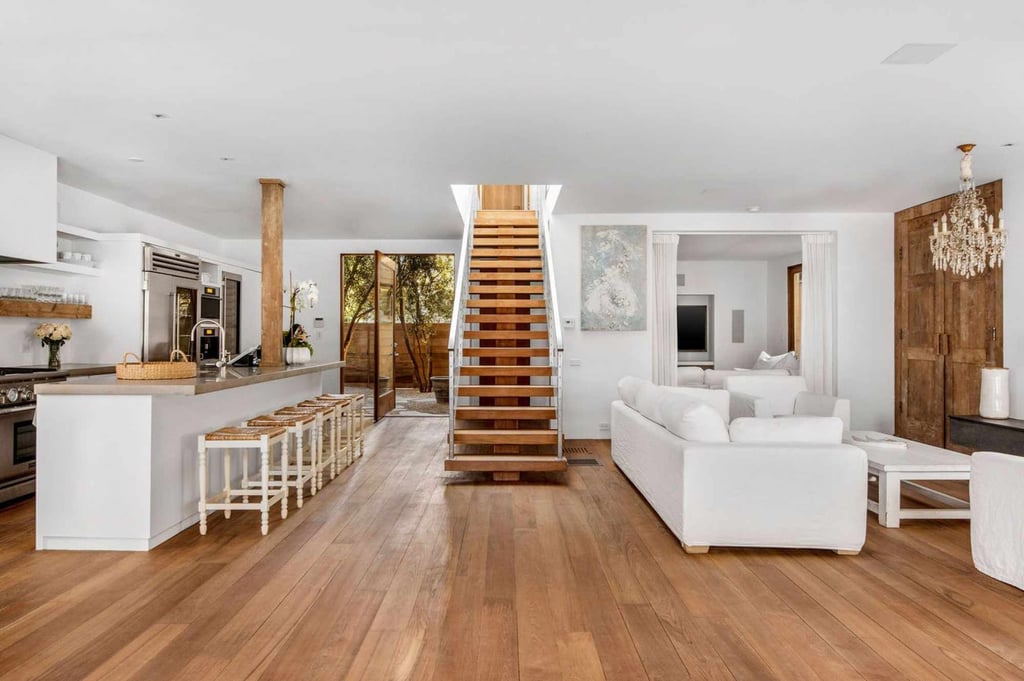 Teak wood features prominently in every room of the home, including the lounge and kitchen, pictured here. Photo: The Fridman Group