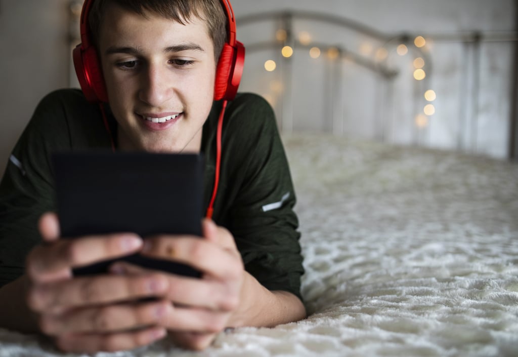 A teenage boy listens to an audiobook. Photo: Getty Images