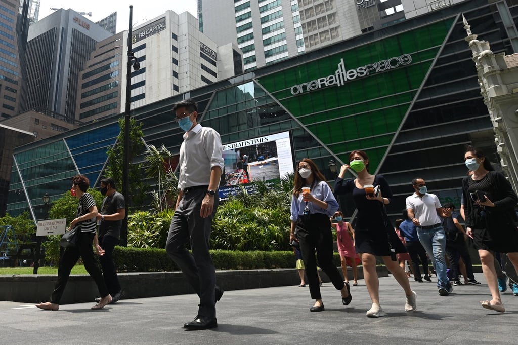 Pedestrians in Singapore at the Raffles Place financial business district. Photo: AFP Pedestrians in Singapore at the Raffles Place financial business district. Photo: AFP