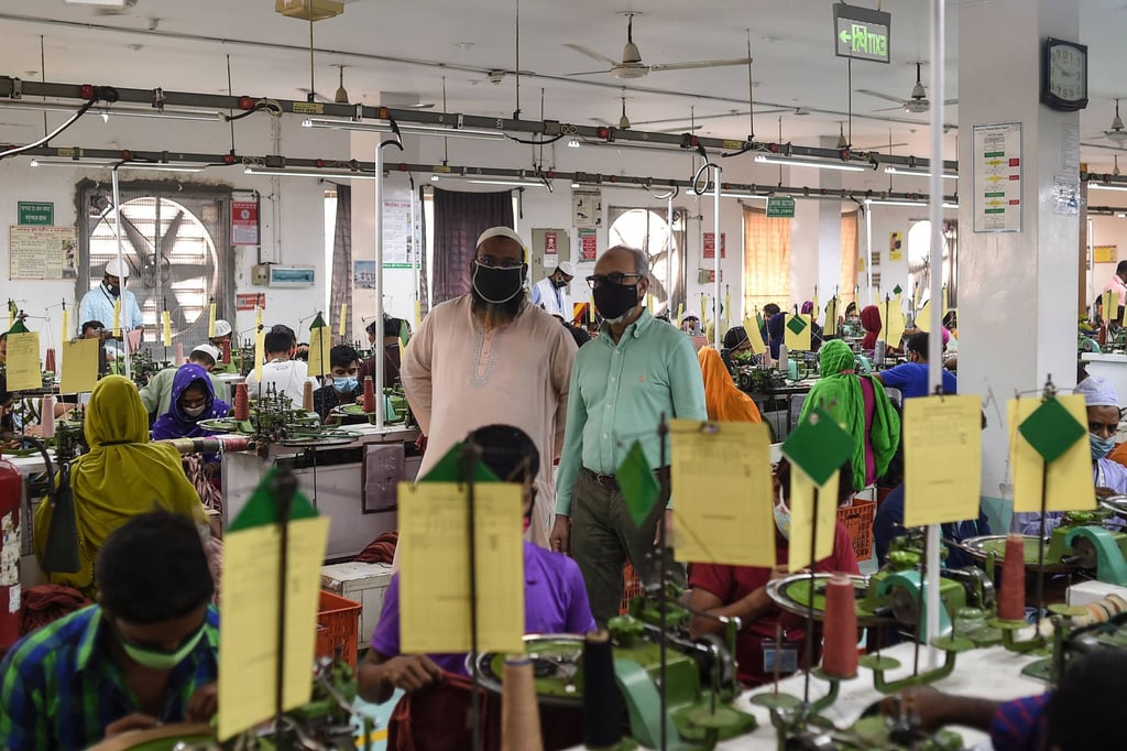 ABM Shamsuddin (in cyan shirt) inspects his garment factory in Gazipur. Photo: AFP