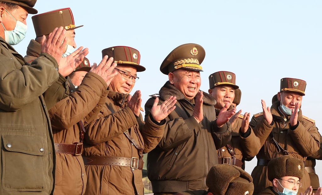 Ri Pyong-chol, the senior leader overseeing the test, and other military officials applaud after the launch of a new tactical guided projectile on Thursday. Photo: KCNA via Reuters