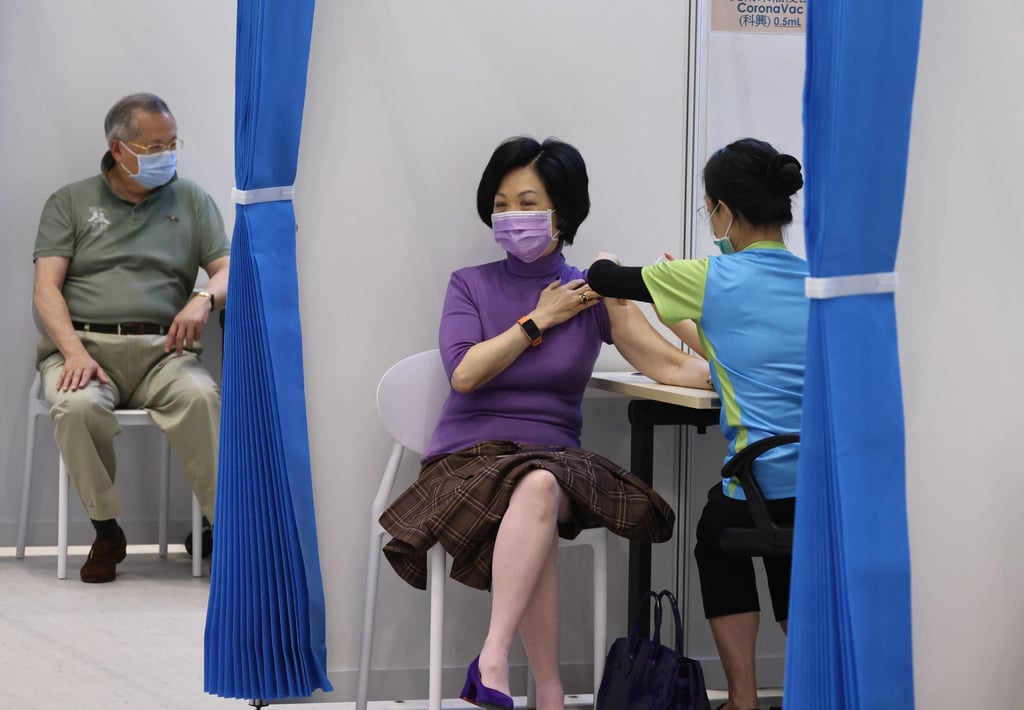 Regina Ip gets her Covid-19 jab but it is her handbag under the table that causes a fuss. Photo: K. Y. Cheng