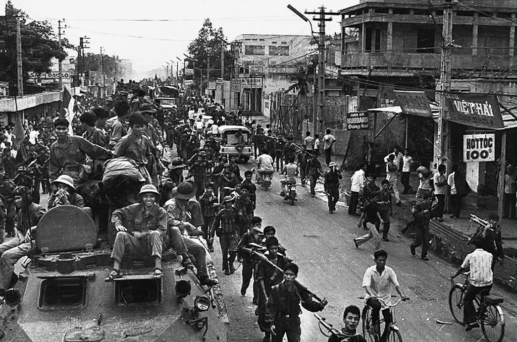 Communist troops on top of trucks and armoured vehicles making their way to the centre of Saigon in 1975 after the city fell under their control. Photo: AFP