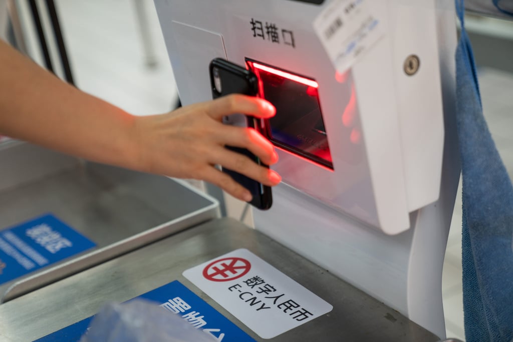Signage for the digital yuan at a self checkout counter inside a supermarket in Shenzhen. China’s central government wants to build a digital economy but first must ensure that personal information is not abused. Photo: Bloomberg