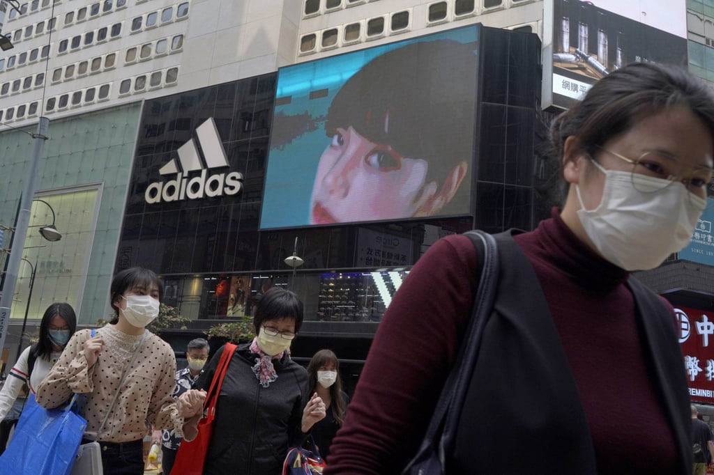 People walk past an Adidas sportswear store in Hong Kong, Saturday, March 27, 2021. Chinese textile and apparel makers are profiting from Chinese boycott of foreign brands. Photo: AP People walk past an Adidas sportswear store in Hong Kong, Saturday, March 27, 2021. Chinese textile and apparel makers are profiting from Chinese boycott of foreign brands. Photo: AP