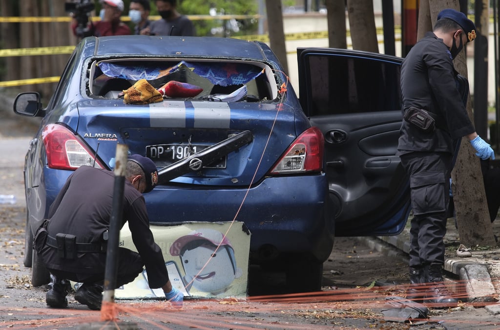 Members of a police bomb squad inspect the area surrounding the site of Sunday’s suicide bomb attack. Photo: AP Members of a police bomb squad inspect the area surrounding the site of Sunday’s suicide bomb attack. Photo: AP