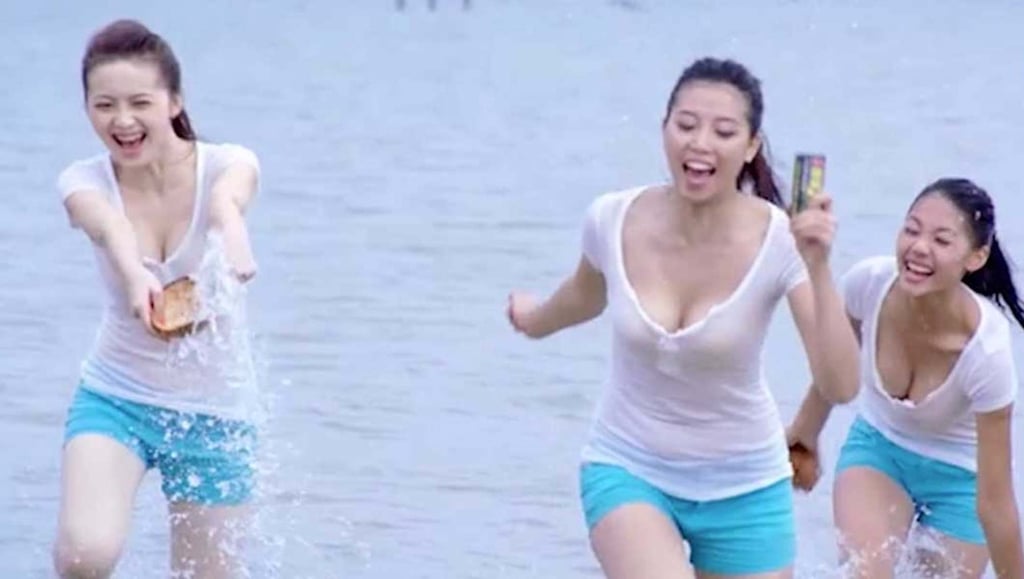A previous controversial advert for the Coconut Palm drink featuring women frolicking on a beach after claims the drink would enlarge breasts. Photo: Weibo